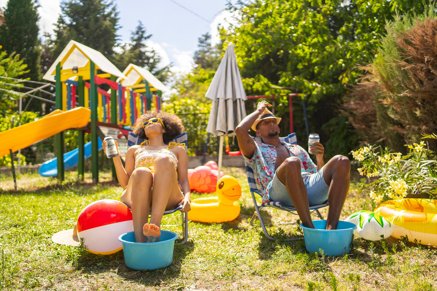Two parents enjoying the sun in their back yard and drinking Comma