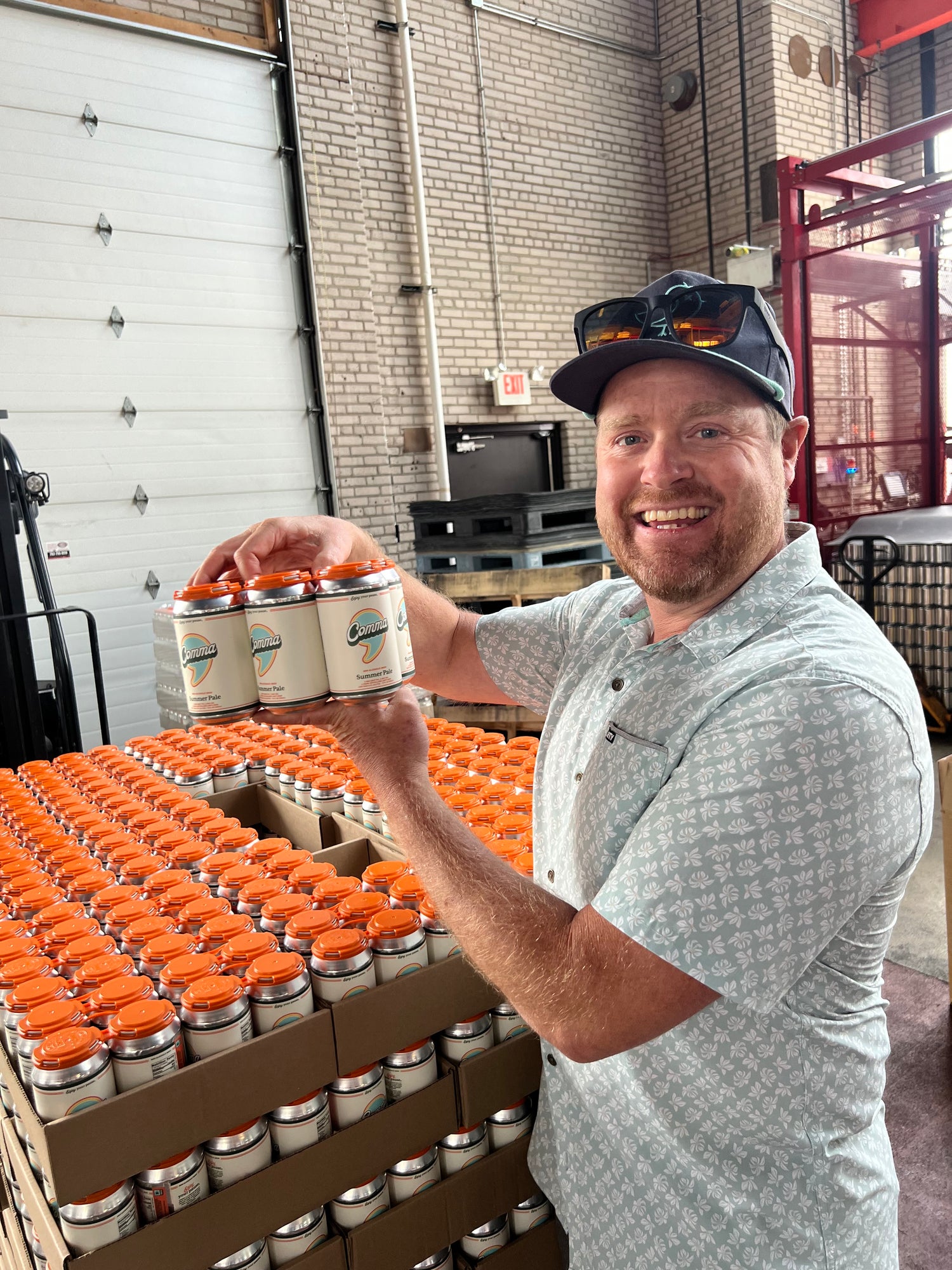 Founder, Kevin Waltermire, proudly holding a six pack of Comma