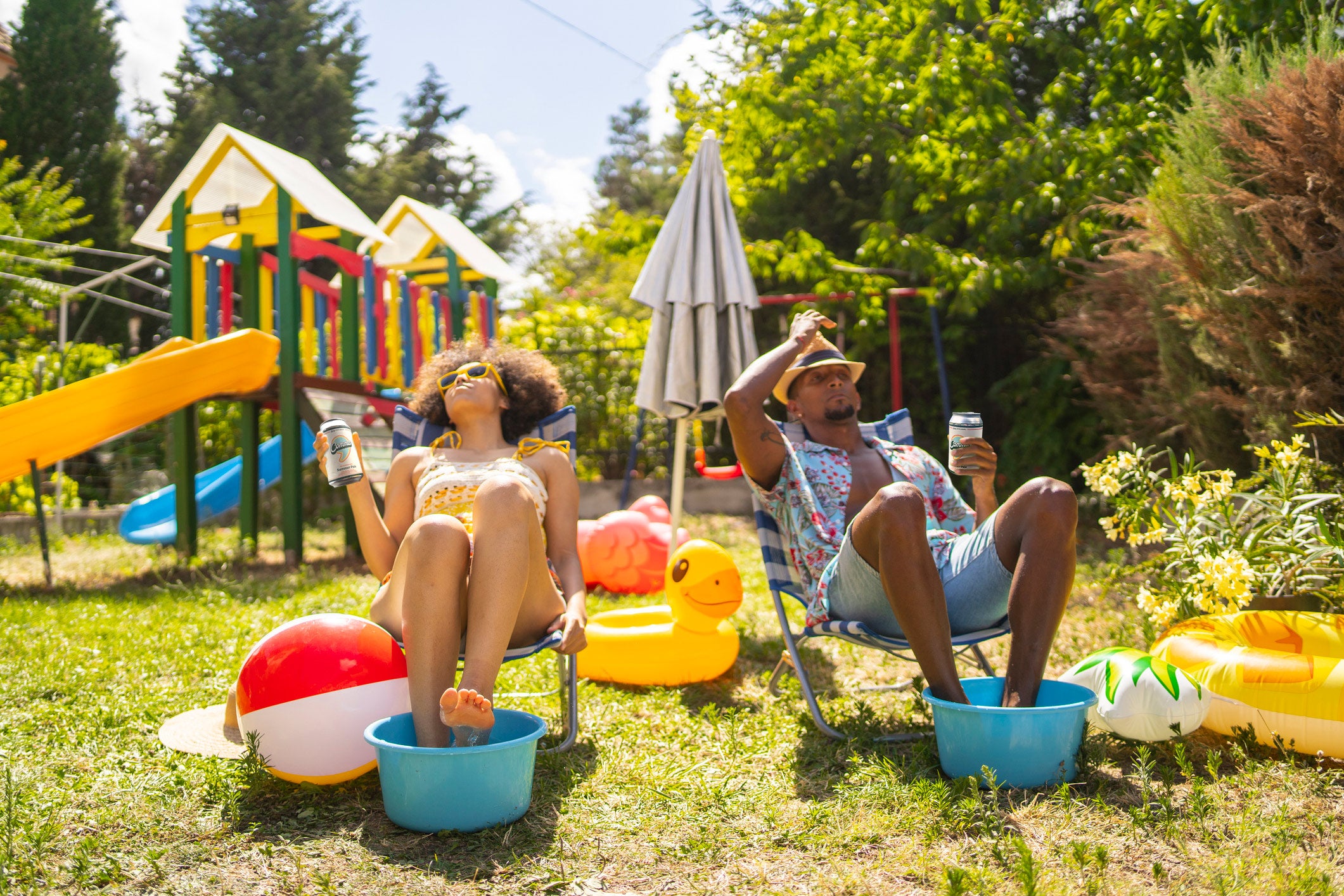 Two parents enjoying the sun in their back yard and drinking Comma 